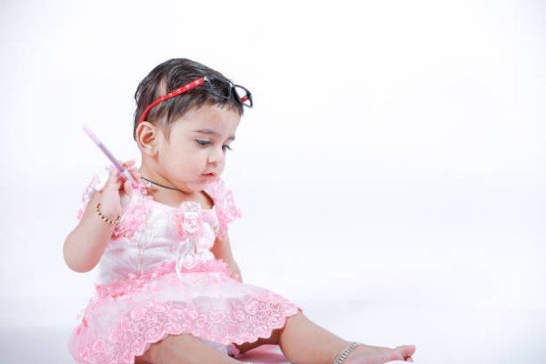 Indian Little Girl with note book , studying